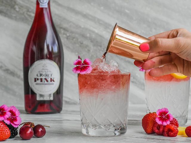 Woman pouring Croft Pink port into glass - Credit: Croft Pink