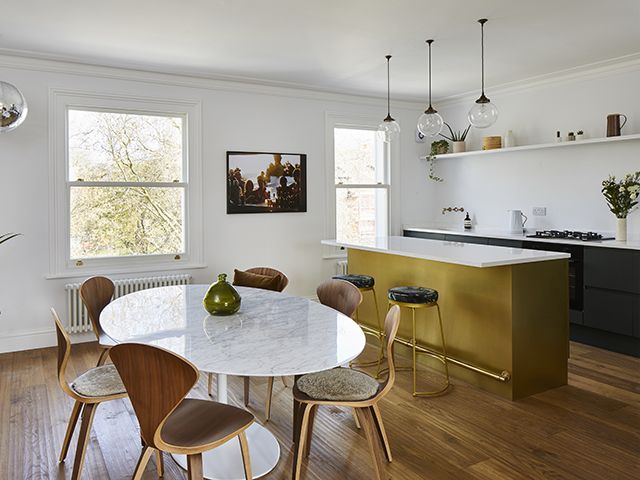 modern london home with brass kitchen island and marble table - home tour - goodhomesmagazine.com