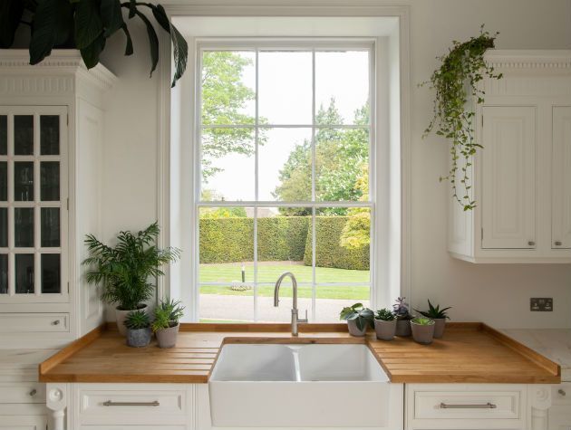 large sash windows in shaker style kitchen looking out over Stavley Court gardens