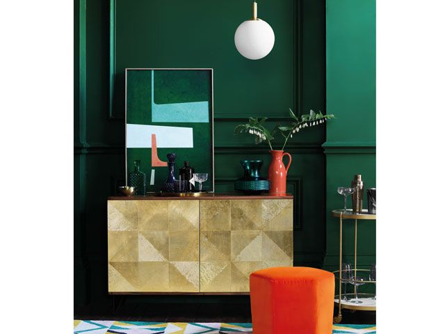 home bar with gold sideboard in a mid century modern style in a green living room by Swoon Editions