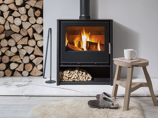 arada woodburning stove in scandi inspired home with logs - goodhomesmagazine.com