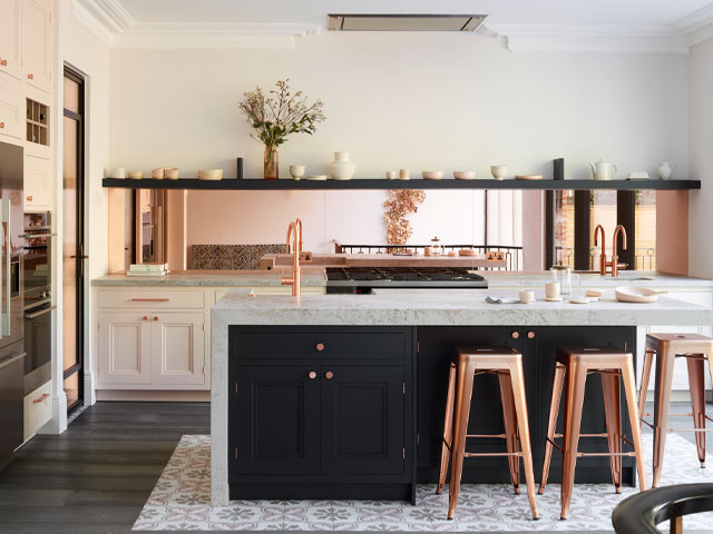 metallic pink splashback with rose bar stools and dark blue kitchen island