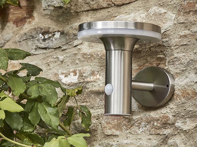 Solar powered outdoor wall light on classic stone building - garden - goodhomesmagazine.com