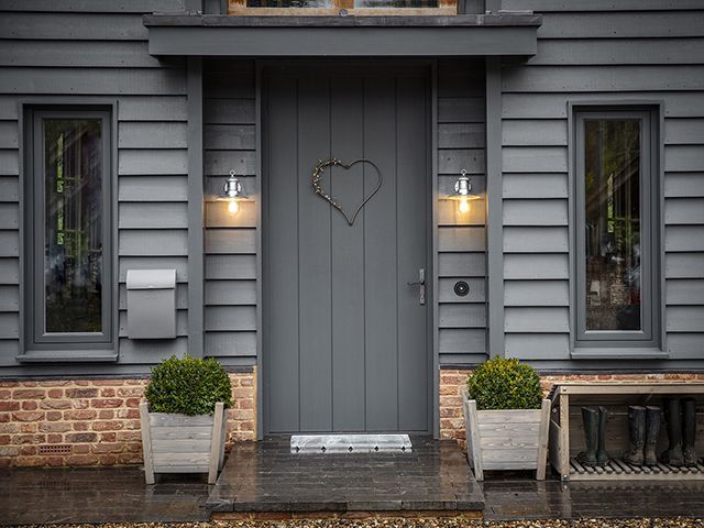 modern front garden with dark grey walls and door and outdoor lighting from Garden Trading - goodhomesmagazine.com