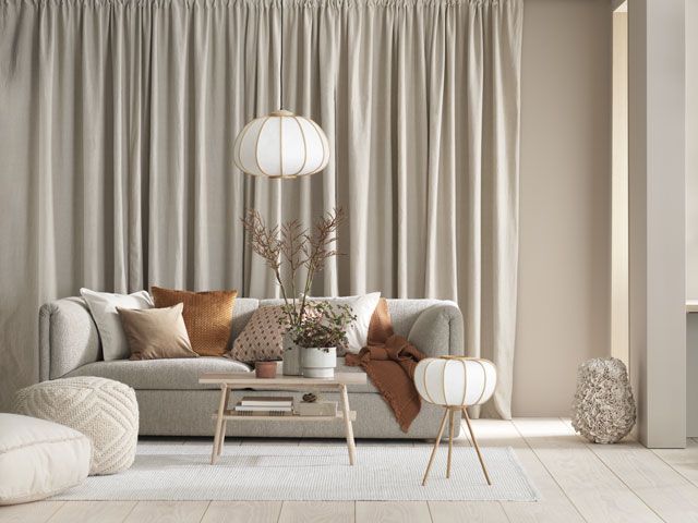 h&m home bamboo light and floor lamp with a sofa in a living room, as part of H&M Home's Aw19 collection
