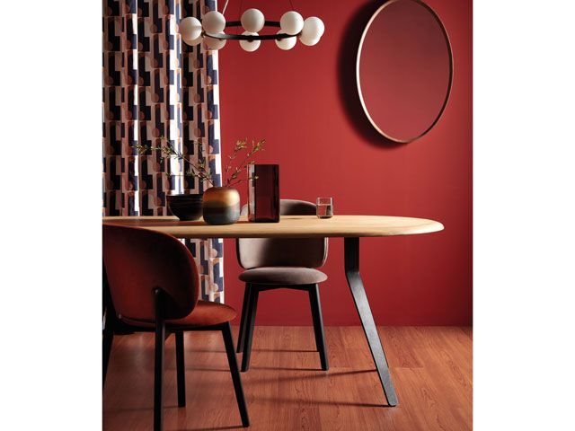 John Lewis red dining room with a mahogany wood table with other mid century modern furniture