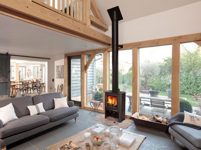 open plan living area with wooden cladding with a Woodwarm Stove Phoenix Eco Design Firegem Convector