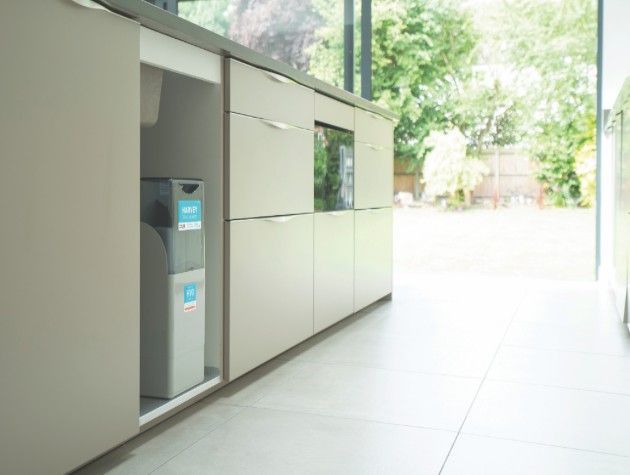 A Harvey water softener under a sink in a kitchen