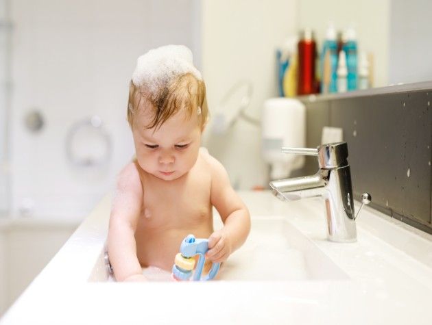 Baby in a bubble bath with lots of suds