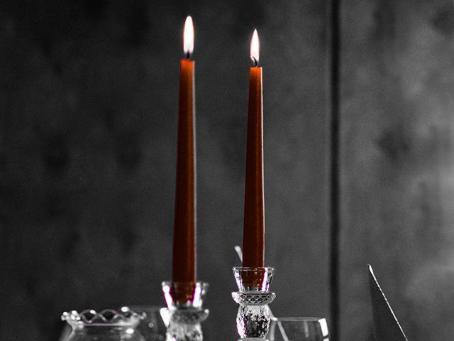 anuja mary unsplash dark red dinner candles halloween decorating idea - inspiration - goodhomesmagazine.com
