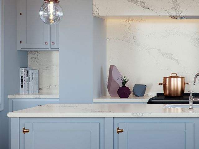 Caesarstone composite Quartz splashback and worktop in blue kitchen 
