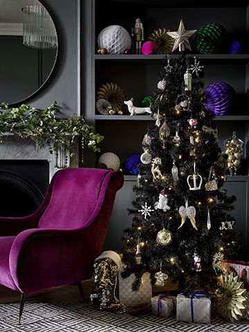 george go for gold trend with gold tree baubles and purple velvet chair and moody grey living room - our top high street Christmas tree looks - inspiration - goodhomesmagazine.com