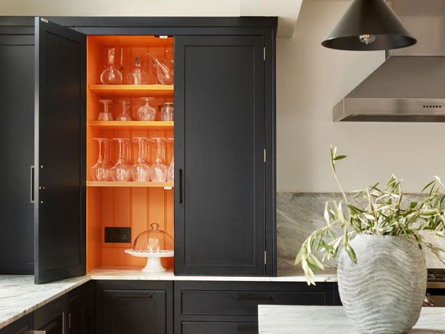 cabinet painted dark with gold inner accent colour