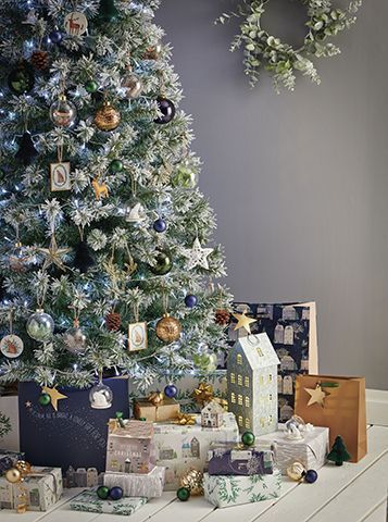 wilko copper decorations on a frosted fake christmas tree with soft grey backdrop - our top high street Christmas tree looks - inspiration - goodhomesmagazine.com