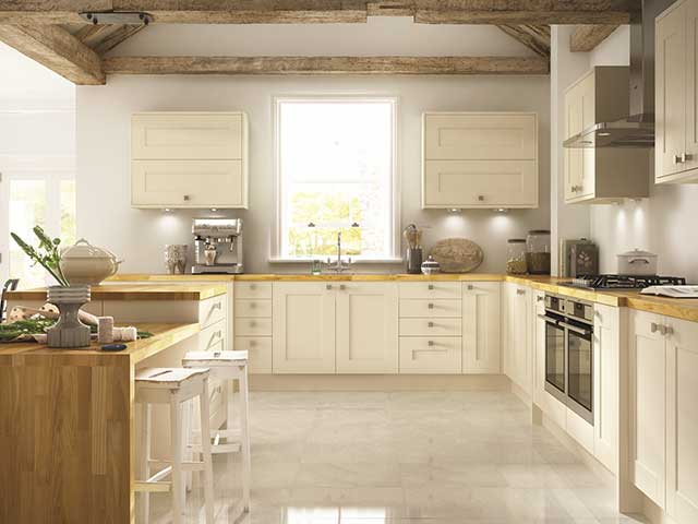 open plan kitchen space with breakfast bar and white cupboards, goodhomesmagazine.com