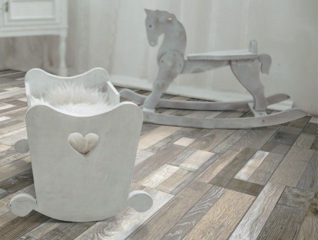 A babys cot next to a rocking chair