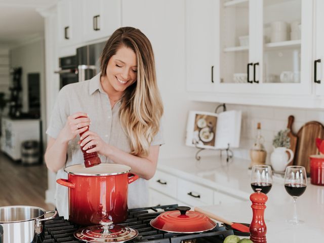 Woman in kitchen seasoning food Becca Tapert Unsplash