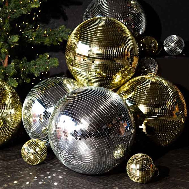 Silver and gold disco balls hang from the ceiling on New Years eve Holiday  Stock Photos