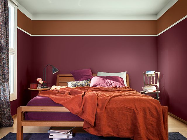 Try a bedroom in warm berry and orange tones 