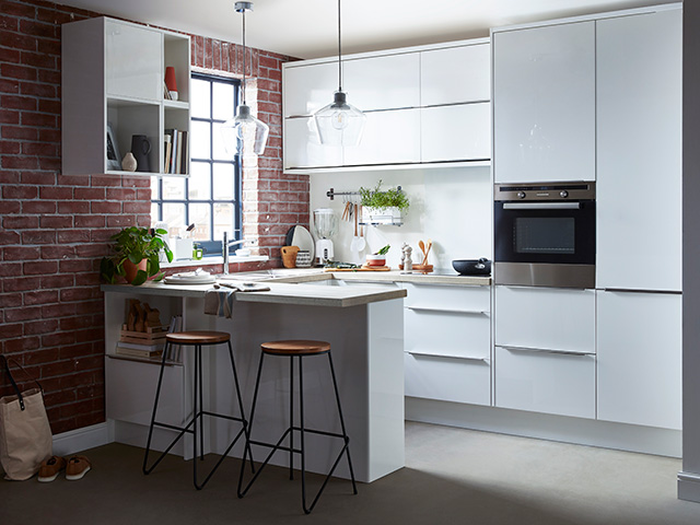 gloss white kitchen with u shape peninsula - goodhomesmagazine.com