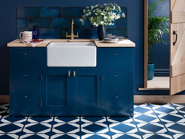 Blue kitchen with Victorian style vinyl flooring 