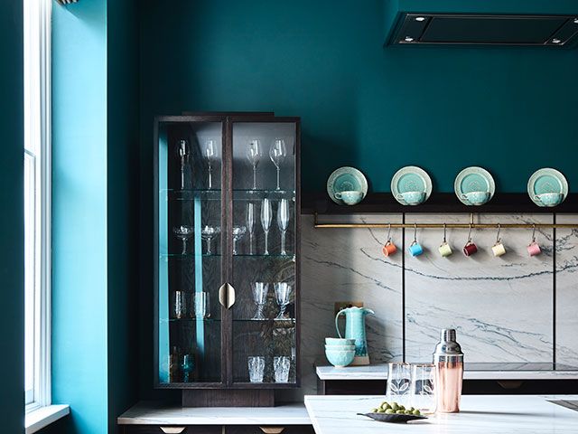 Luxury blue kitchen with open cabinetry in London apartment - home tour - goodhomesmagazine.com