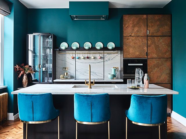 Luxury kitchen with blue and copper finishes in London apartment - goodhomesmagazine.com