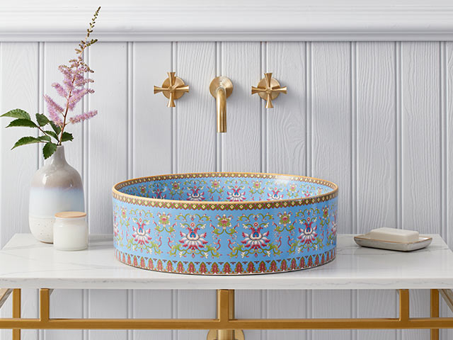 Blue patterned basin with white panelled walls behind on stylish unit