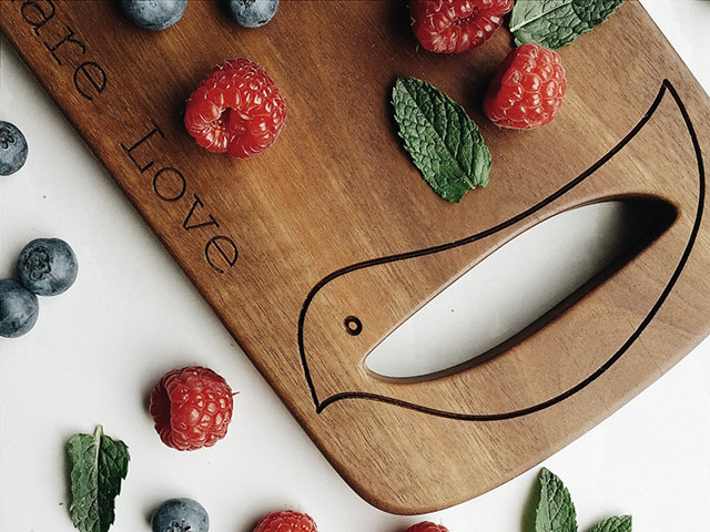Wooden Valentine's home gifts serving board with raspberries and blueberries