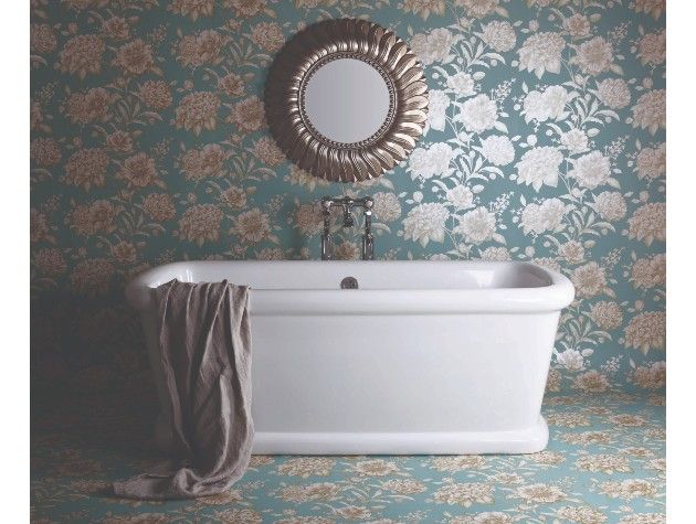a white free standing bath in a floral decorated bathroom