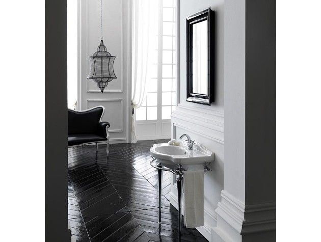 a white sink with chrome legs in a stylish home