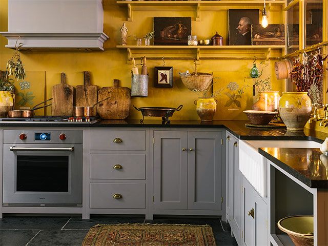 grey and yellow kitchen in devol's new york showroom - goodhomesmagazine.com