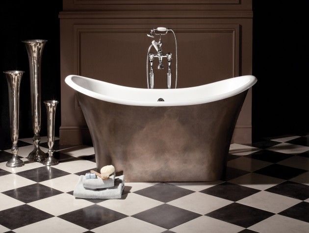 free standing bath in a bathroom with black and white tiles