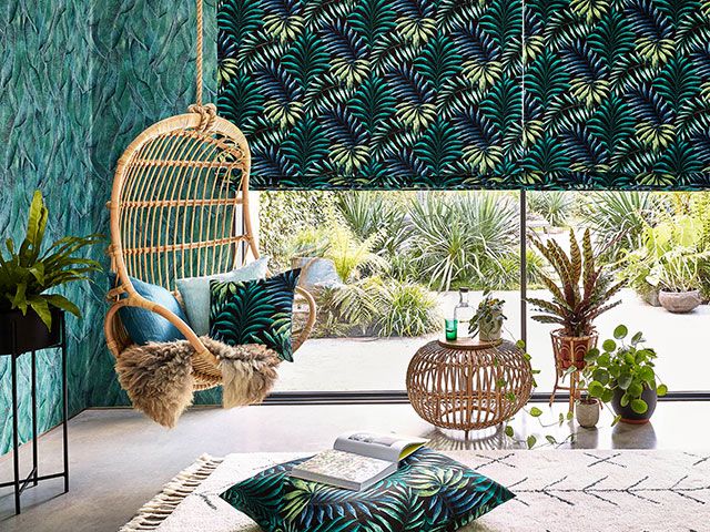 jungle palm print blind in a jungle-inspired living room: hillary's Mirrissa Twilight Roman Blinds