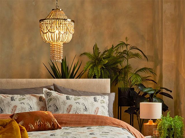 beaded chandelier over bed - goodhomesmagazine.com