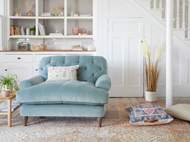 pastel blue snuggler chair with neutral accessories