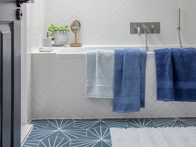 cotton towels hanging over side of a bath - goodhomesmagazine.com