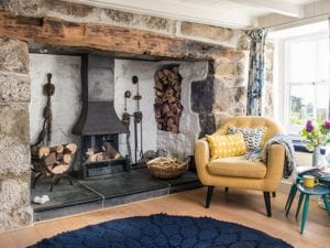 old open fireplace with yellow armchair - goodhomesmagazine.com