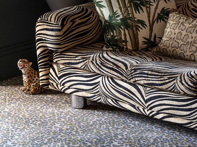 qirky leopard snow capret from alternative flooring with tiger sofa and leopard ornament - goodhomesmagazine.com