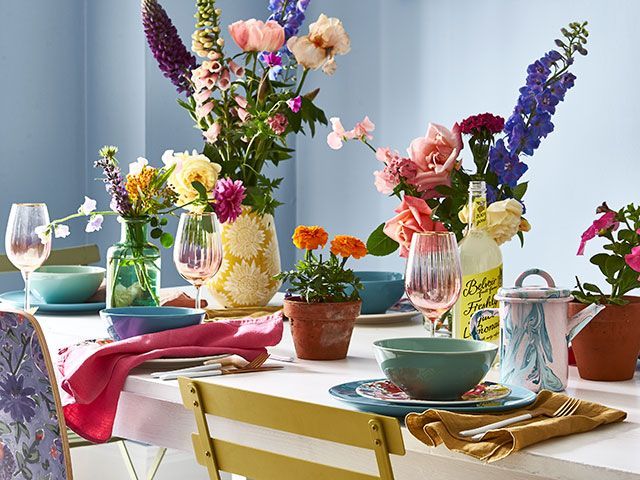 colourful dining table scheme with flowers - goodhomesmagazine.com