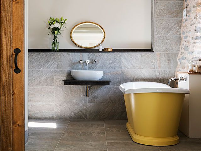 yellow bath in a country bathroom - goodhomesmagazine.com