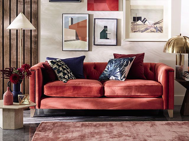living room with red sofa and rug - goodhomesmagazine.com
