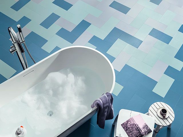 blue gradient bathroom floor in herringbone pattern - goodhomesmagazine.com 
