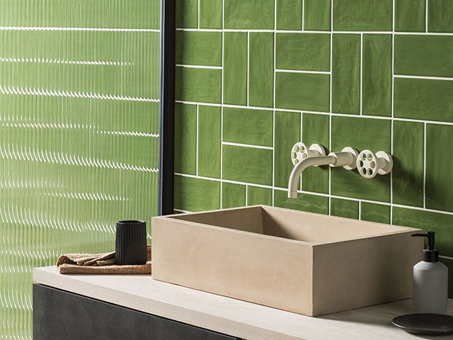 green bathroom tiles with reed shower screen and countertop sink - goodhomesmagazine.com