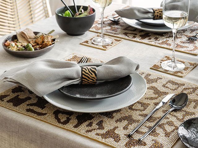 Dining table set up with leopard and zebra print accessories - goodhomesmagazine.com