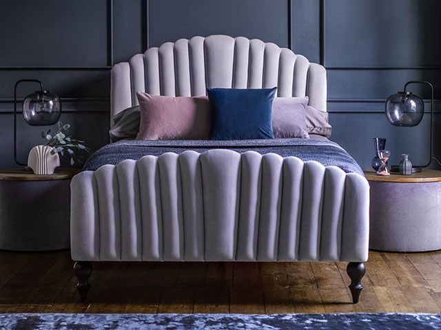 scalloped upholstered bed in grey, with blue bedroom - goodhomesmagazine.com