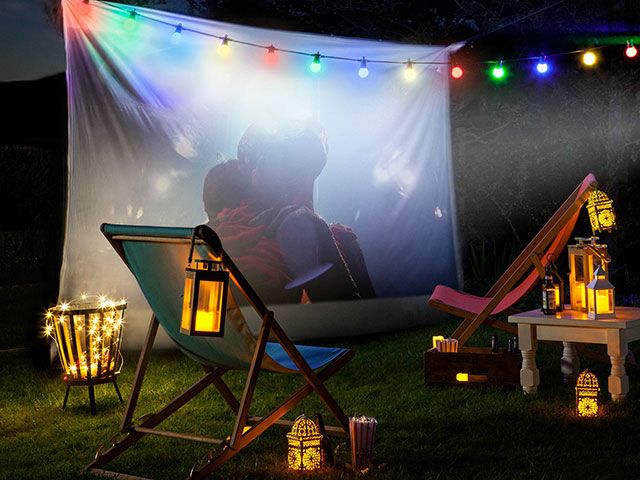garden movie night with projector on big screen - goodhomesmagazine.com