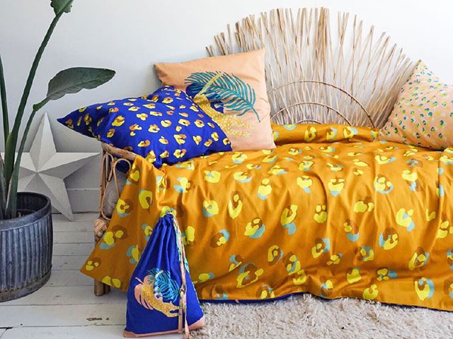 bed with colourful leopard print duvet and cushion - goodhomesmagazine.com