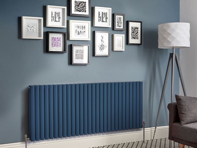 navy blue radiator - 5 ways to save money on your heating - inspiration - goodhomesmagazine.com