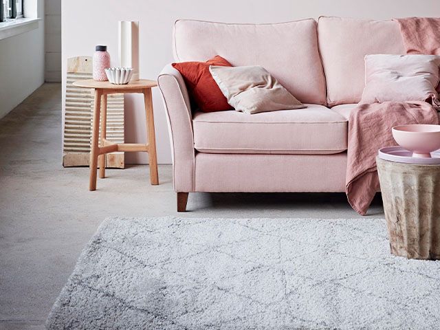 pink sofa in neutral living room - 5 ways to save money on your heating - inspiration - goodhomesmagazine.com